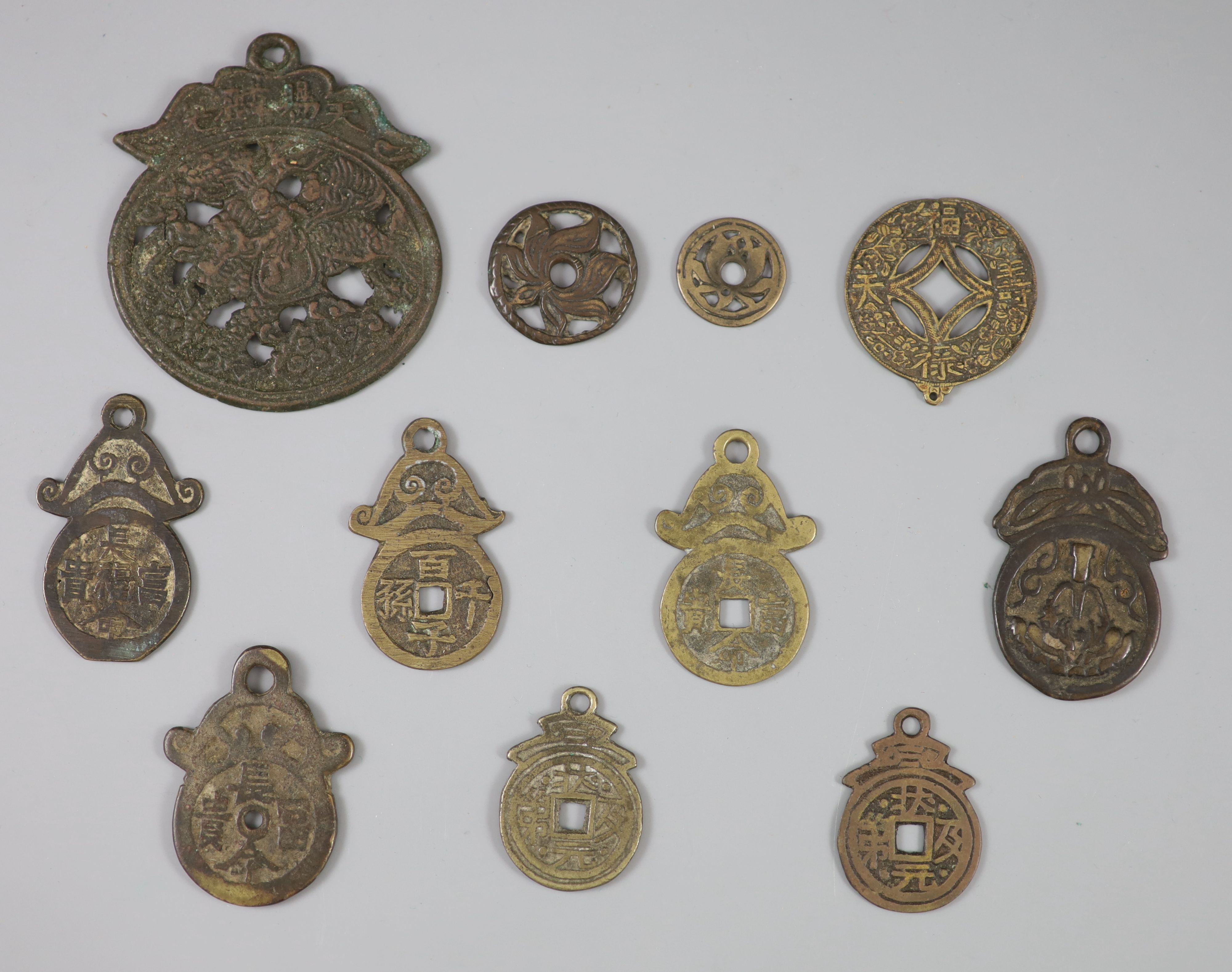 China, 11 bronze charms or amulets, Qing dynasty or earlier,